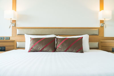 Pillows arranged on bed at home