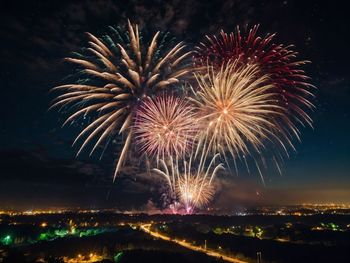 Low angle view of firework display at night