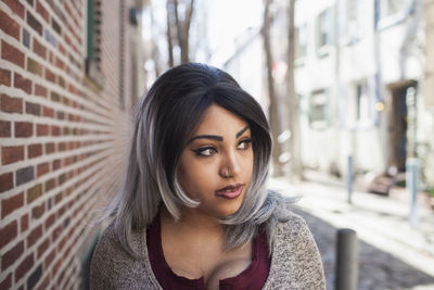 Portrait of beautiful young woman in city