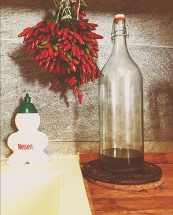 Close-up of red flower in glass bottle