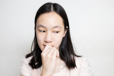 Portrait of a beautiful woman against white background