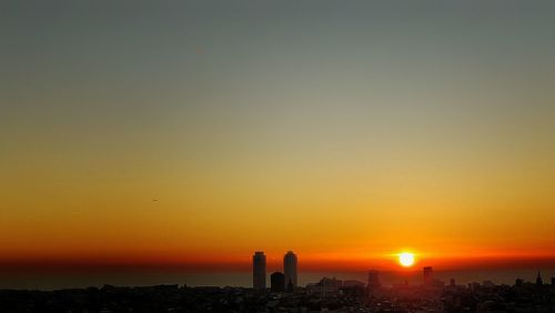 Silhouette of city at sunset