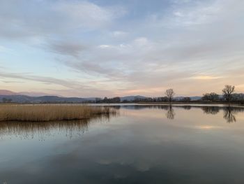 Scenic view of lake against sky during sunset