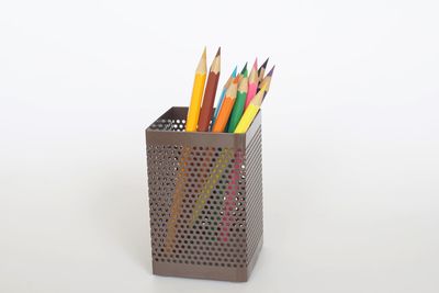Close-up of colored pencils against white background
