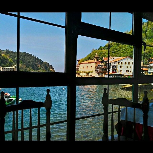 window, water, architecture, built structure, men, indoors, glass - material, transparent, building exterior, sky, reflection, lifestyles, leisure activity, nautical vessel, river, transportation, railing, mode of transport