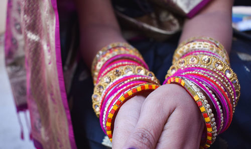 Close-up of woman hand wearing bangles