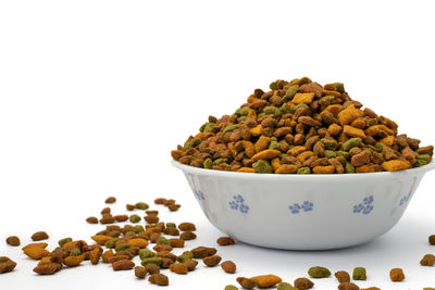 Close-up of fresh vegetables in bowl against white background