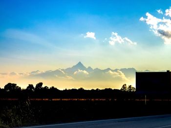 Scenic view of silhouette landscape against sky at sunset