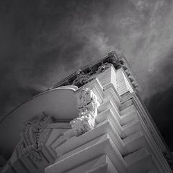 Low angle view of building against cloudy sky