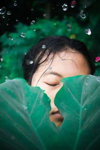 Close-up of girl with leaf