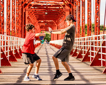 Lateral view of 2 boys fighting kung fu