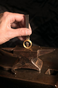 Cropped hand of person shaping ring at workshop