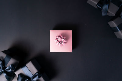 High angle view of hand holding paper with text on table