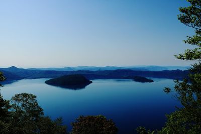 Scenic view of sea against clear blue sky