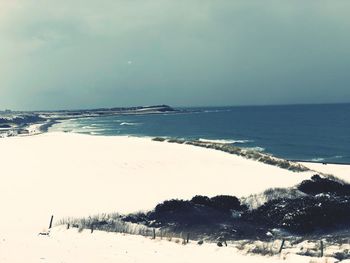 Scenic view of sea against sky during winter