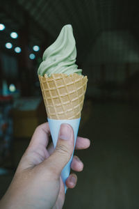 Hand holding ice cream cone