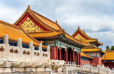 Low angle view of temple against cloudy sky