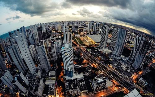 High angle view of cityscape against cloudy sky