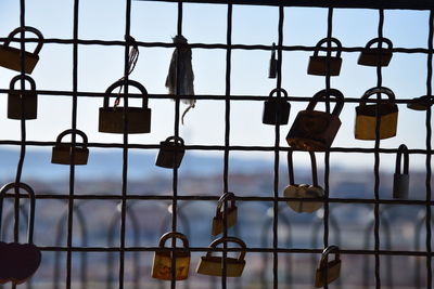 Padlocks hanging on railing