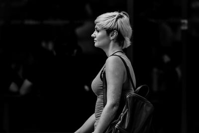 Side view of woman looking at camera