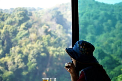 Portrait of man photographing through smart phone