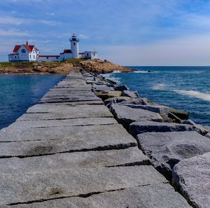 Pathway leading to lighthouse against the sky