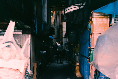 People on alley amidst buildings in city