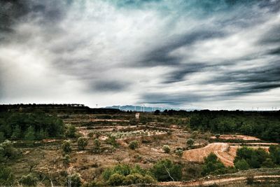 Scenic view of agricultural field against storm clouds