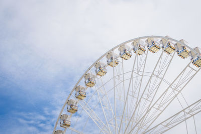 Low angle view of ferris wheel against sky