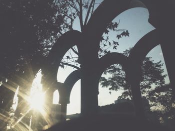 Low angle view of silhouette bridge against clear sky