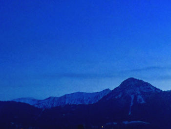 Scenic view of mountains against clear blue sky at dusk