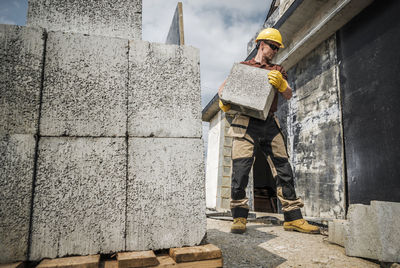 Rear view of man standing against wall