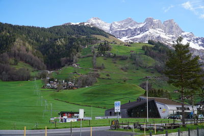 Scenic view of field and mountains against sky