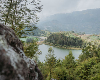 Scenic view of lake and mountains against sky