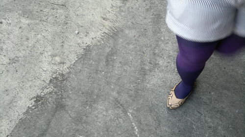 Low section of woman standing on ground