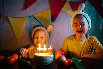 Vegetarian cake with candles birthday vegetables kids in bunny ears girl crying