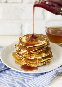 Syrup pouring on pancake