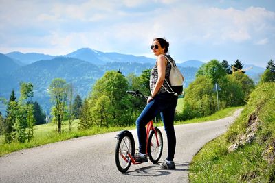 Woman riding bicycle on road