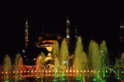 Fountain in city at night