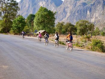 People riding bicycle on road