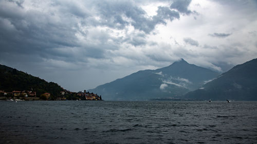 Scenic view of sea and mountains against sky