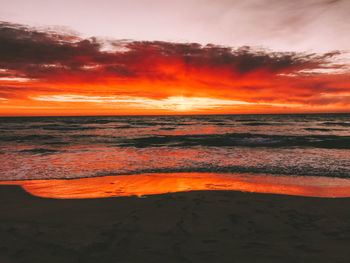 Scenic view of sea against romantic sky at sunset