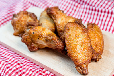 Close-up of chicken wings on tablecloth