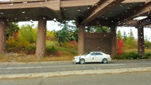 Vehicles on road seen through window