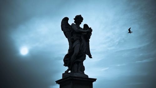 Low angle view of statue against cloudy sky