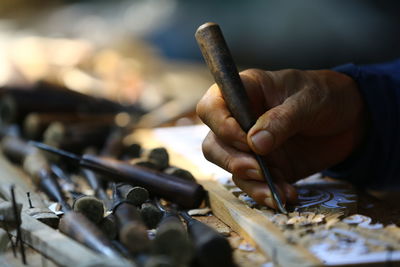 Close up of a man working on a wooden