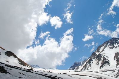 Low angle view of snowcapped mountain against sky