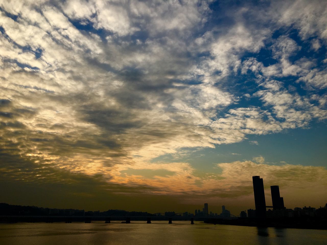 sunset, silhouette, water, waterfront, sky, cloud - sky, architecture, built structure, sea, river, scenics, beauty in nature, building exterior, cloud, tranquility, tranquil scene, nature, dusk, cloudy, transportation