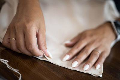 Close-up of woman hand on table