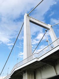 Low angle view of suspension bridge against sky